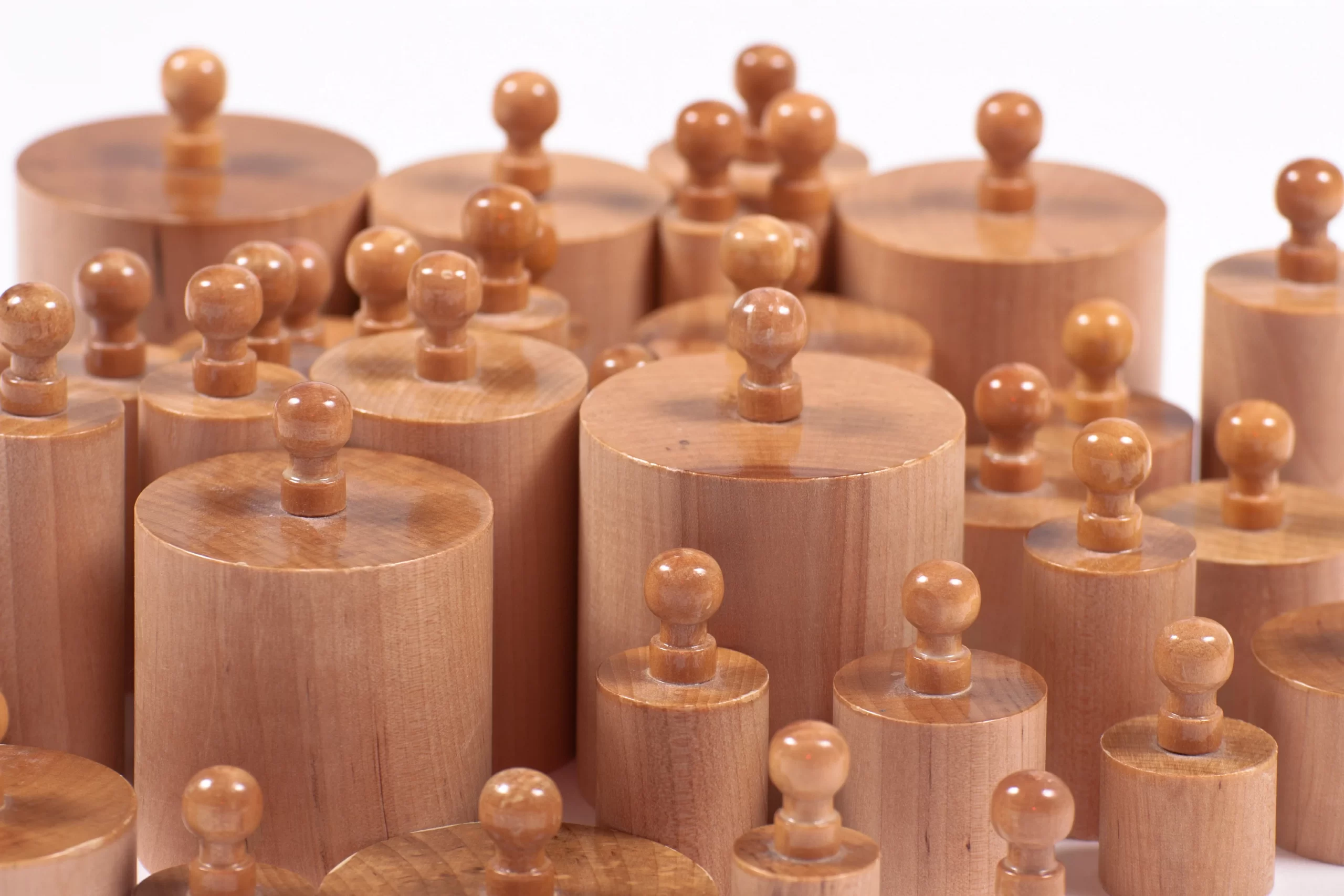 Close-up of polished wooden Montessori cylinder materials